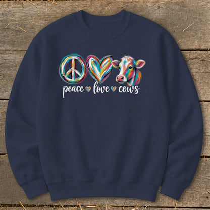 Peace, love, cows graphic with colorful peace sign, heart, and cow on dark blue sweatshirt.