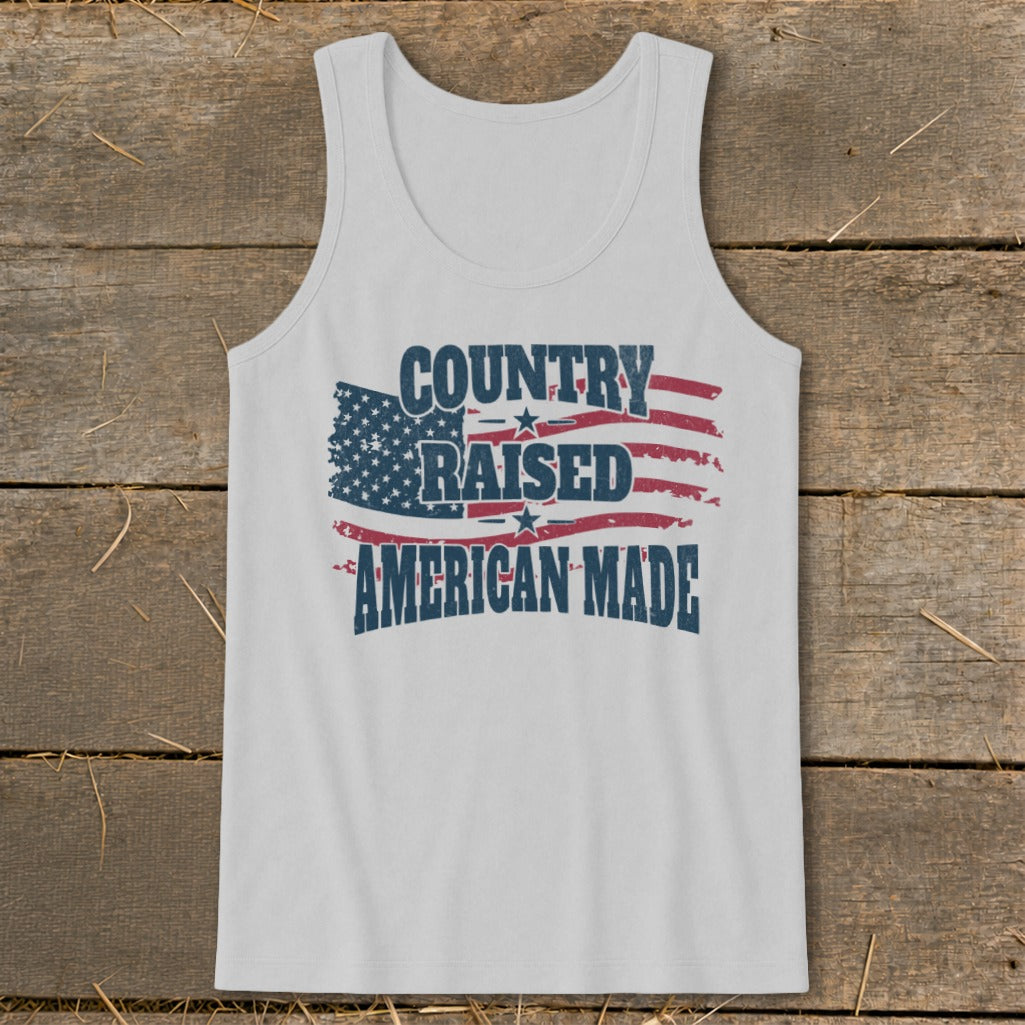 White tank top with distressed American flag and text "COUNTRY RAISED AMERICAN MADE".