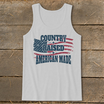 White tank top with distressed American flag and text "COUNTRY RAISED AMERICAN MADE".