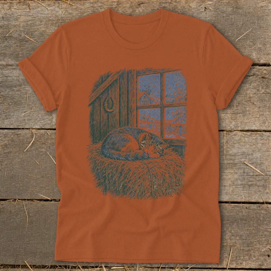 T-shirt with a cat sleeping on straw in front of a barn window.