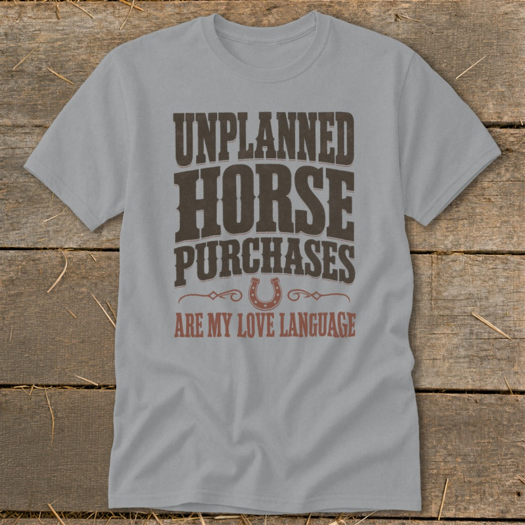 Grey t-shirt with "Unplanned Horse Purchases Are My Love Language" text and horseshoe graphic.