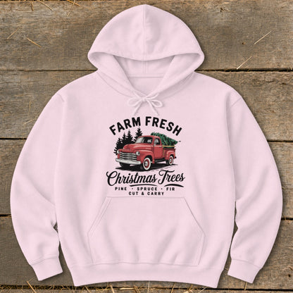Pink hoodie with "Farm Fresh Christmas Trees" graphic featuring a red truck.