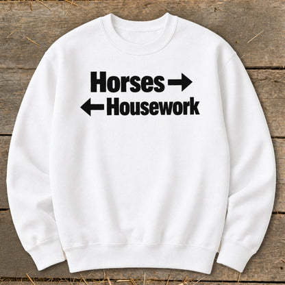 White crewneck sweatshirt with black text reading Horses pointing right and Housework pointing left.