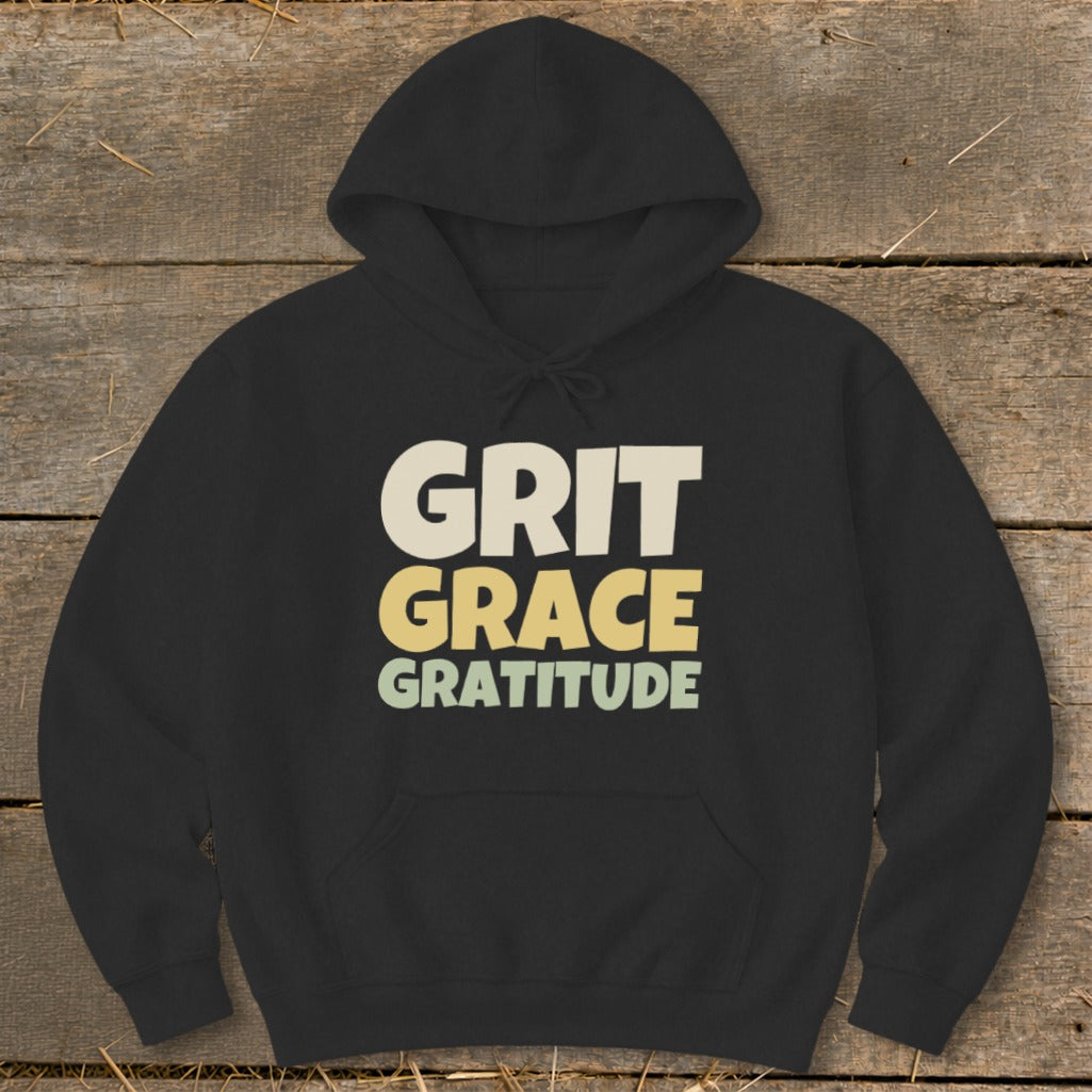 Black hooded sweatshirt featuring the text GRIT GRACE GRATITUDE in stacked white, yellow, and green letters.