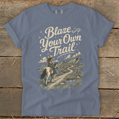 Blue t-shirt with "Blaze Your Own Trail" text and a woman riding a horse on a desert path.