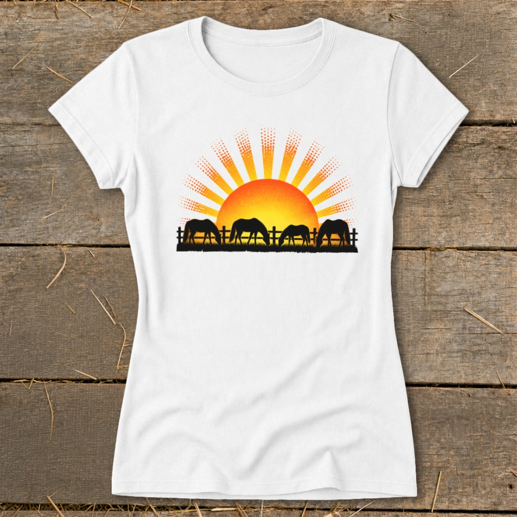 White t-shirt featuring a sunrise graphic with grazing horses and a fence silhouette.