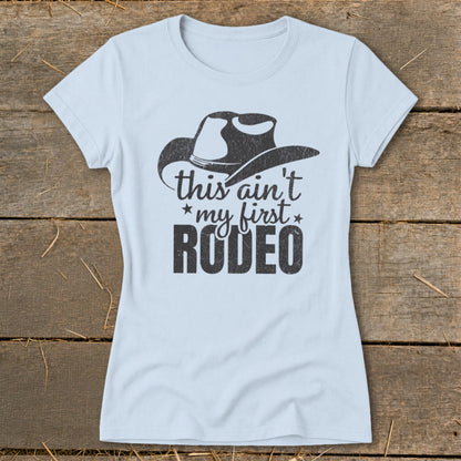 Light blue t-shirt with a cowboy hat graphic and the text "this ain't my first RODEO".