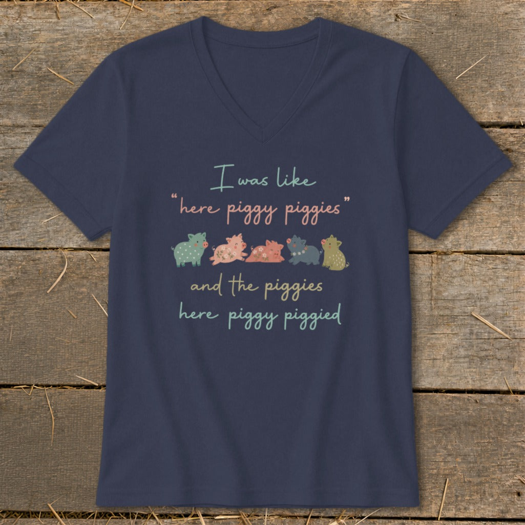Navy t-shirt with a v-neck, featuring a quote and cartoon pigs.