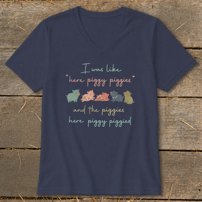Navy t-shirt with a v-neck, featuring a quote and cartoon pigs.