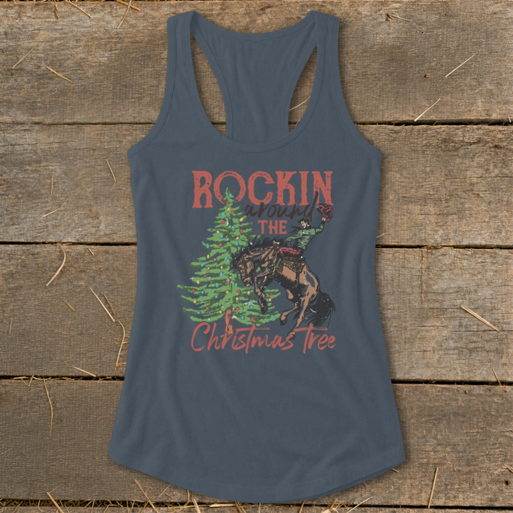 Graphic on a tank top reads "Rockin Around The Christmas Tree" with a cowboy on a bucking horse.