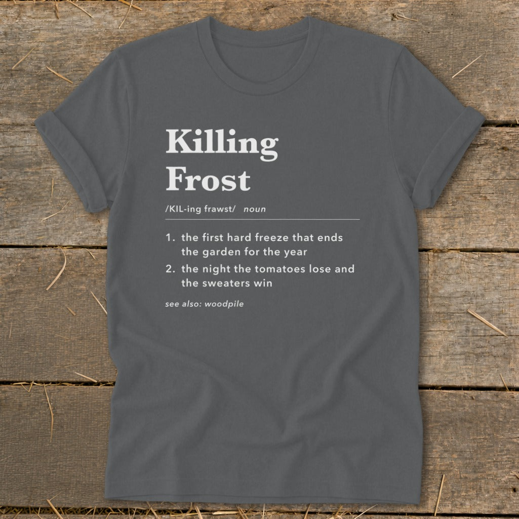 Dark gray t-shirt with white dictionary-style text defining Killing Frost on a rustic wooden background.