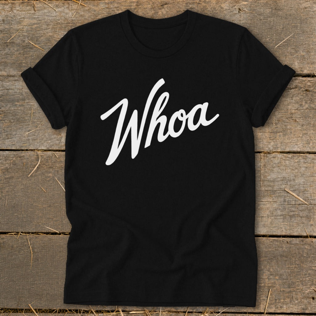 Black t-shirt with white "Whoa" text in cursive lettering.