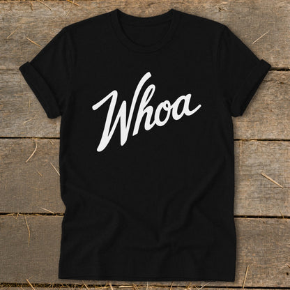 Black t-shirt with white "Whoa" text in cursive lettering.