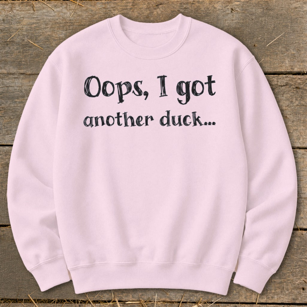 Light pink sweatshirt with black text that reads "Oops, I got another duck..."