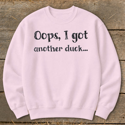 Light pink sweatshirt with black text that reads "Oops, I got another duck..."