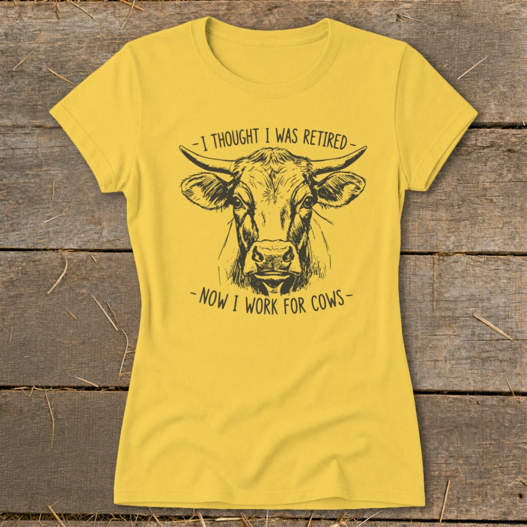 Yellow t-shirt with a black line drawing of a cow's head and text.