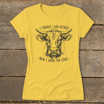 Yellow t-shirt with a black line drawing of a cow's head and text.