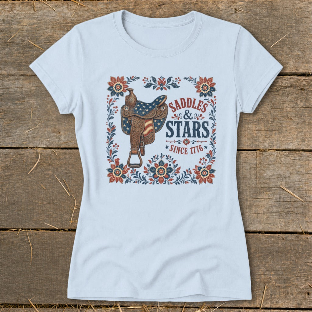 Light blue t-shirt with saddle, stars, and text "Saddles & Stars Since 1776".