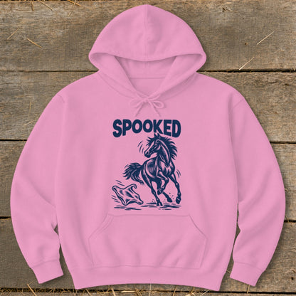 Pink hoodie with navy blue graphic of a startled horse and ghost, reading "SPOOKED".
