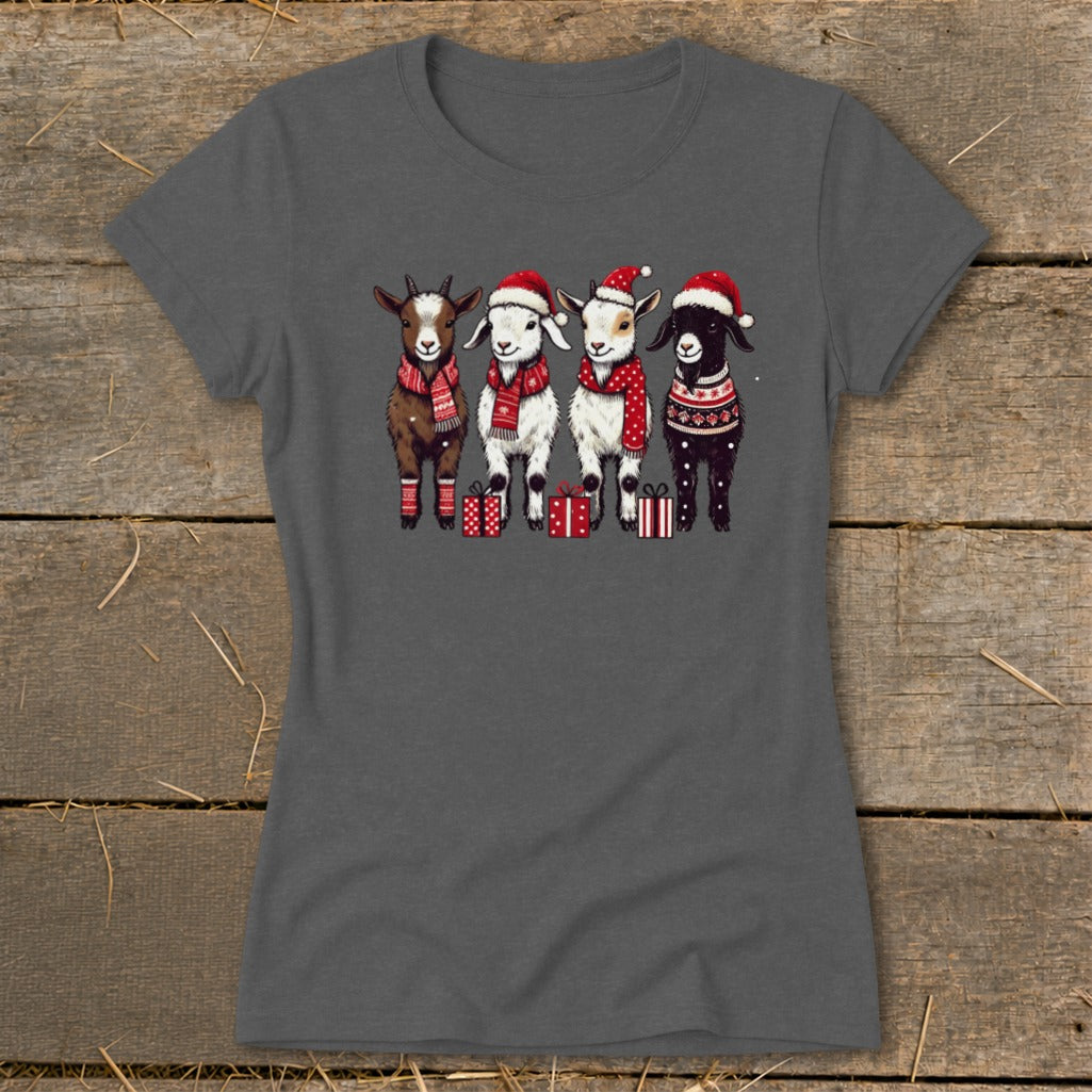 Four cartoon goats in Santa hats and scarves stand in a row with gifts.