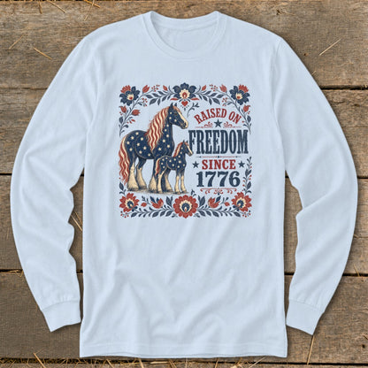 Long sleeve shirt with patriotic horses and "Raised on Freedom Since 1776" graphic.