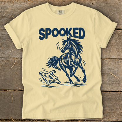 Light yellow t-shirt with "SPOOKED" text and a startled horse running from a ghost.