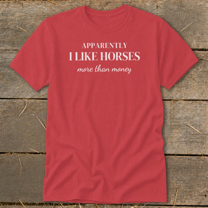 Red t-shirt with white text "Apparently I like horses more than money".