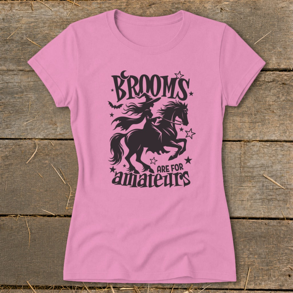 Pink t-shirt with "Brooms are for amateurs" and witch riding horse graphic.