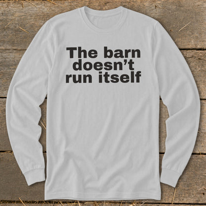 Long sleeve shirt with black text: "The barn doesn't run itself."