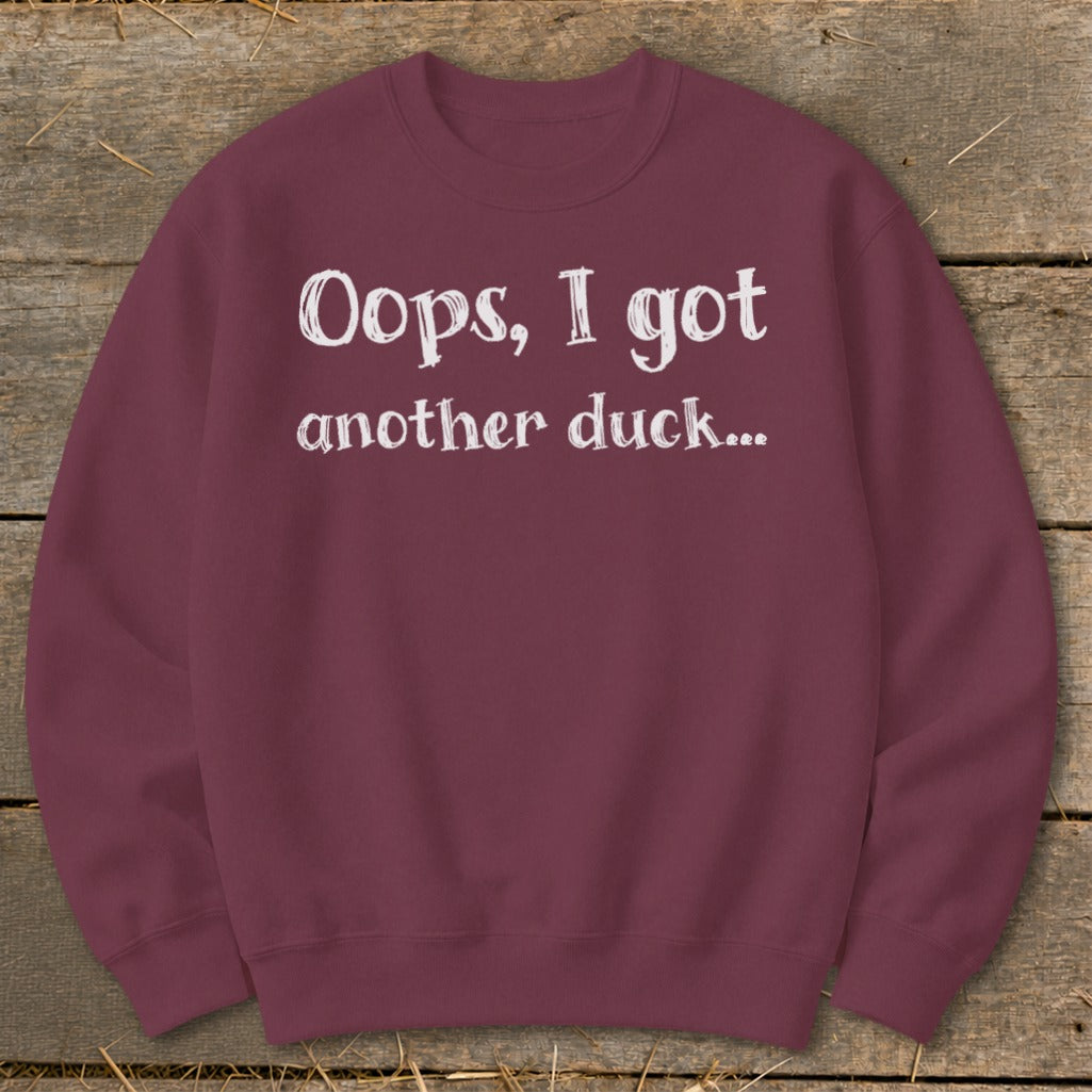 Maroon sweatshirt with white text: "Oops, I got another duck..."
