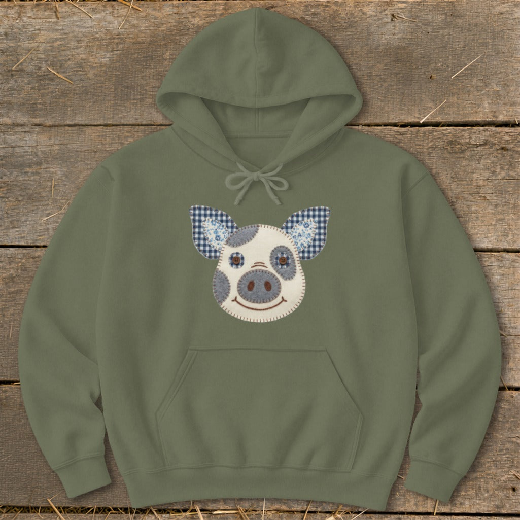 Olive green hoodie with a stitched pig face applique on the front.