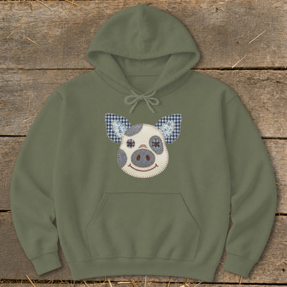 Olive green hoodie with a stitched pig face applique on the front.