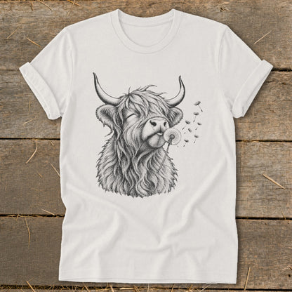 Highland cow with closed eyes blowing dandelion seeds on a white t-shirt.