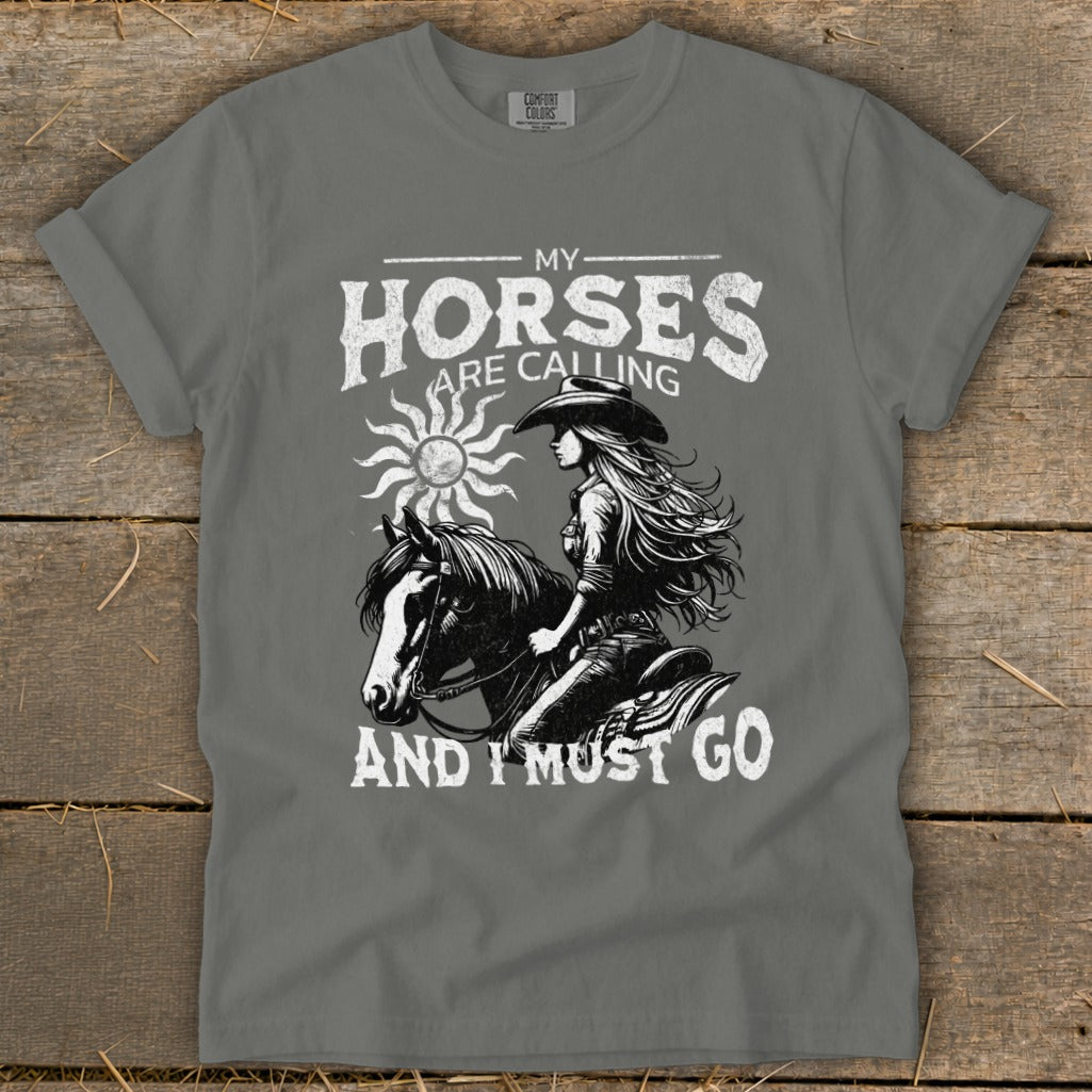 T-shirt with "My Horses Are Calling And I Must Go" text and illustration of a woman riding a horse.