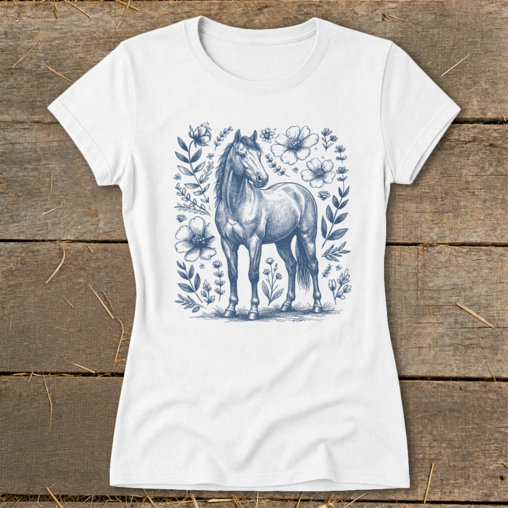 White t-shirt with a blue sketch of a horse surrounded by floral elements.