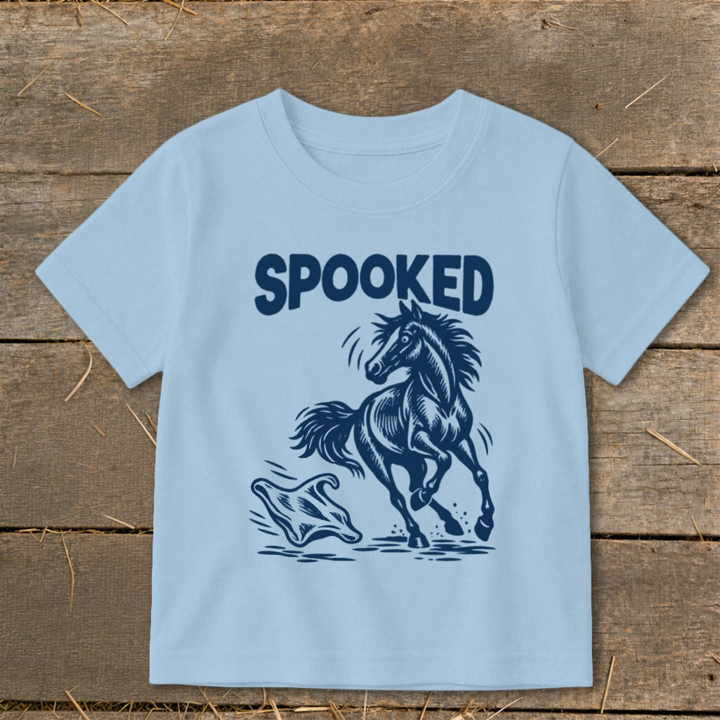 Light blue t-shirt with navy graphic of a startled horse and ghost, text "SPOOKED".