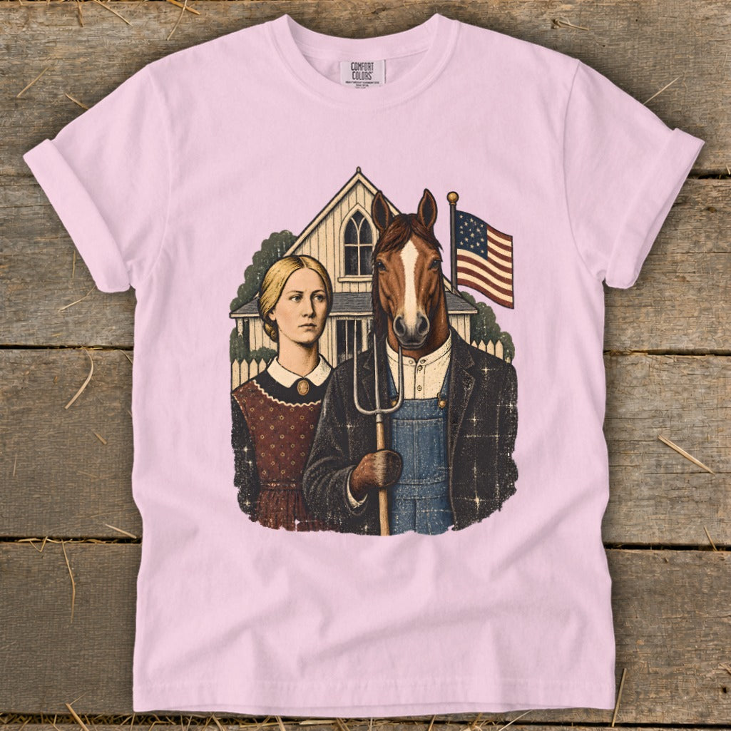 Light pink t-shirt featuring a parody of American Gothic with a horse holding a pitchfork.