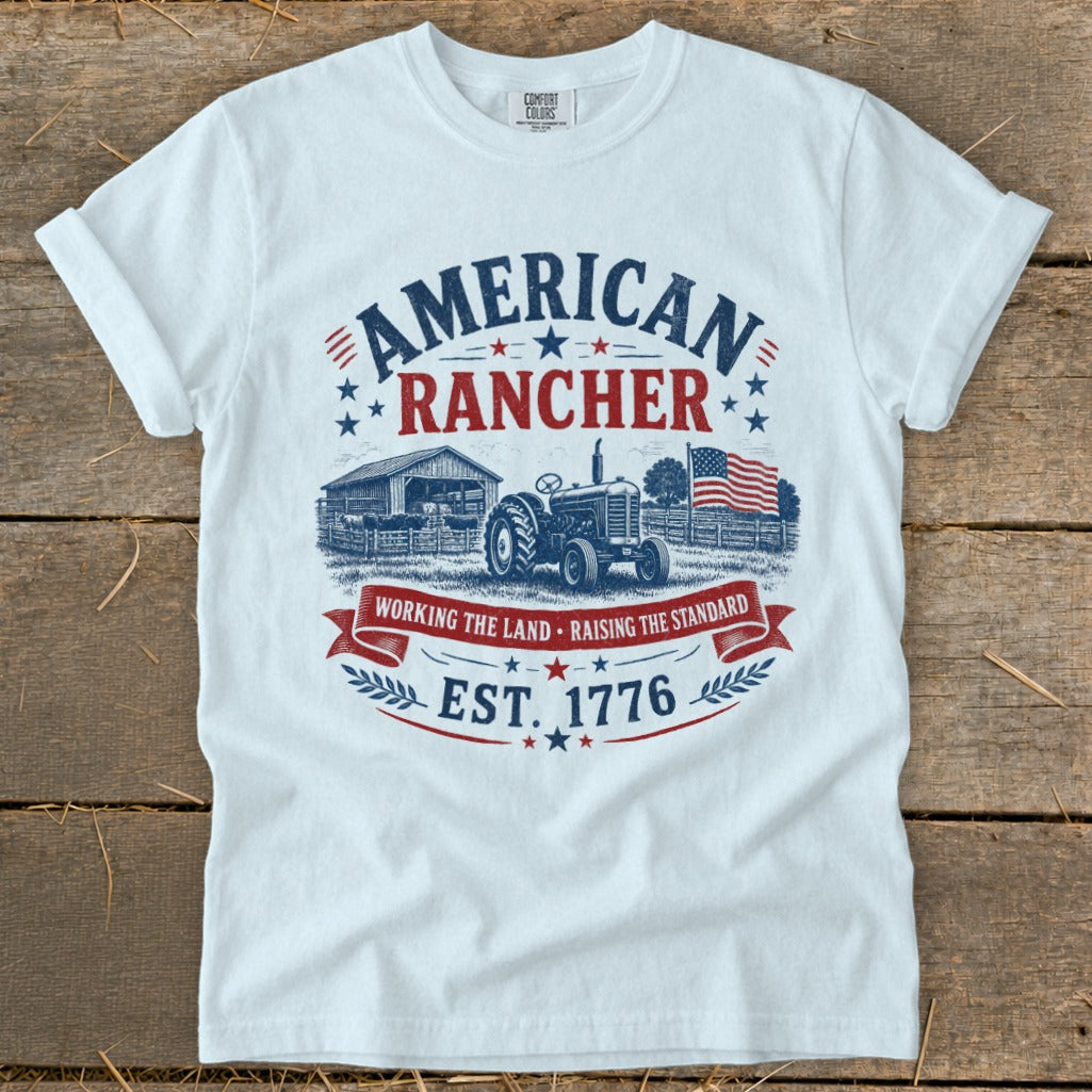 White t-shirt with "American Rancher Est. 1776" graphic featuring a tractor and barn.