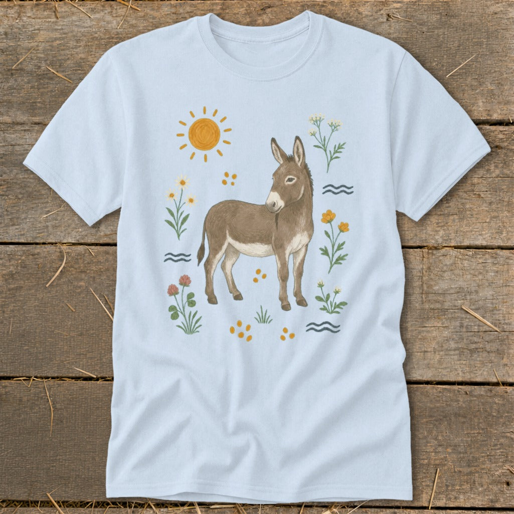 Light blue t-shirt with a watercolor-style donkey, sun, and wildflowers illustration.