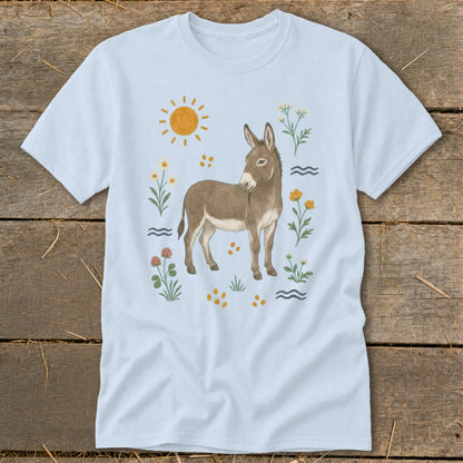Light blue t-shirt with a watercolor-style donkey, sun, and wildflowers illustration.