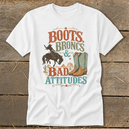 T-shirt graphic with text "Boots, Broncs & Bad Attitudes", a bucking bronco rider, and cowboy boots.
