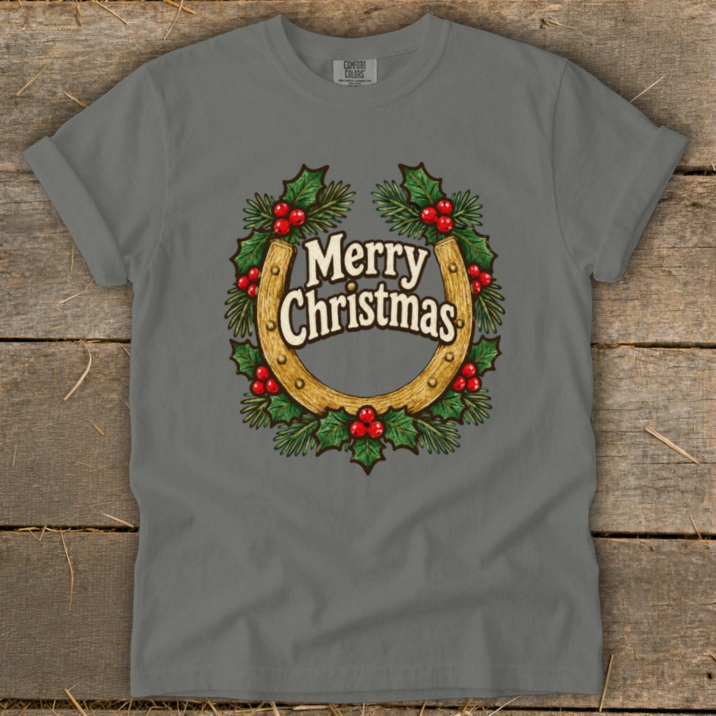 Grey t-shirt with a horseshoe wreath graphic saying "Merry Christmas".