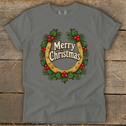 Grey t-shirt with a horseshoe wreath graphic saying "Merry Christmas".
