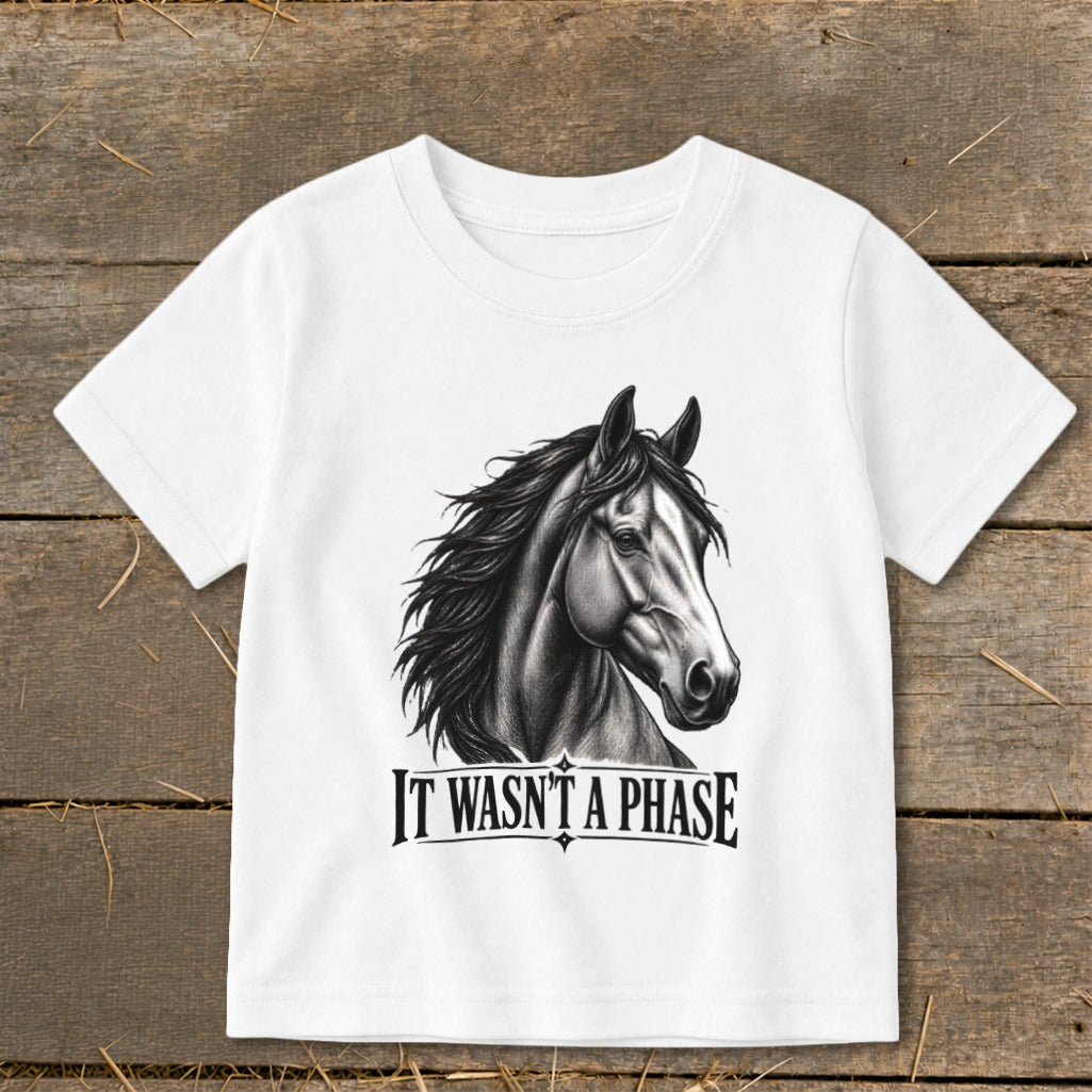 White t-shirt with a drawing of a horse and the text "IT WASN'T A PHASE."