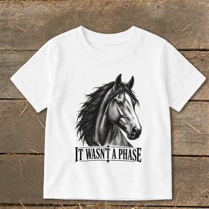 White t-shirt with a drawing of a horse and the text "IT WASN'T A PHASE."