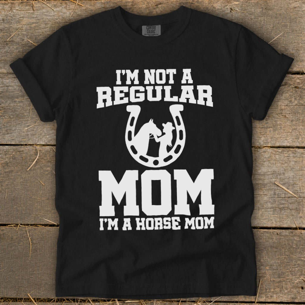 Black t-shirt with white text "I'M NOT A REGULAR MOM I'M A HORSE MOM" and horseshoe graphic.
