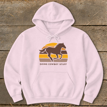 Pink hoodie with a running horse graphic and "DOING COWBOY STUFF" text.