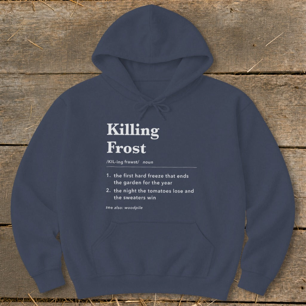 Dark blue hooded sweatshirt featuring white dictionary-style text defining killing frost on a wooden background.