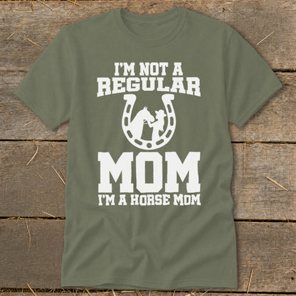 Olive green t-shirt with white text and horse graphic reading "I'm Not A Regular Mom, I'm A Horse Mom".