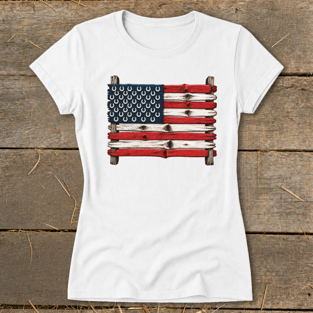 A white short-sleeved t-shirt features a graphic of the American flag made of weathered wooden planks with horseshoes.